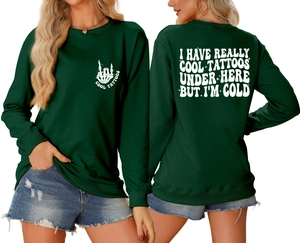 Detail of dark green crewneck sweatshirt featuring white tattoo-themed back lettering