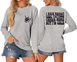 Detail of light grey crewneck sweatshirt featuring skull hand print and back text