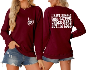 Front and back view of burgundy sweatshirt with white 'COOL TATTOOS' art print