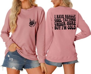Detailed front and back views of pink crewneck sweatshirt with skull and tattoo slogan