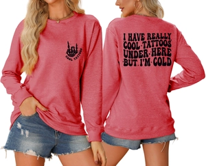 Detail of coral red crewneck sweatshirt featuring black graphic print on chest and back