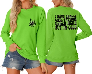 Close-up of neon green sweatshirt with skull graphic and cool tattoos back print