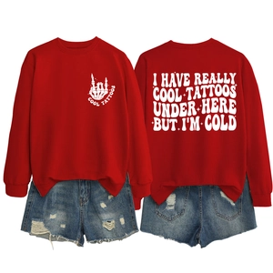 Front and back view of red crewneck sweatshirt with skull graphic and tattoo slogans
