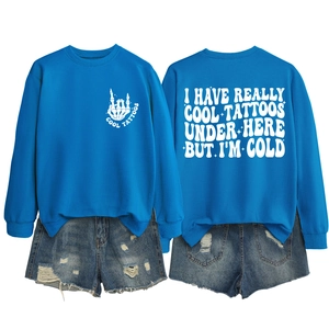 Detail view of bright blue crewneck sweatshirt with cool tattoos back print design