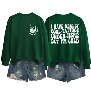 Detail of green crewneck sweatshirt with white back print and cool tattoos slogan text