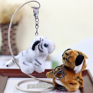 Cute white and orange tiger plush keychains with metal clips on decorative stand