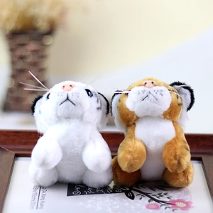 Close-up of cute plush tiger dolls in white and yellow with realistic stripe details