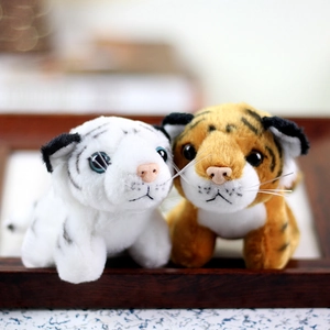 Close-up of plush white and orange tiger toys with detailed stripes and soft fur