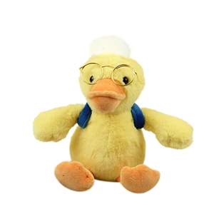 Cute yellow plush duck toy with gold round glasses and blue backpack on white background