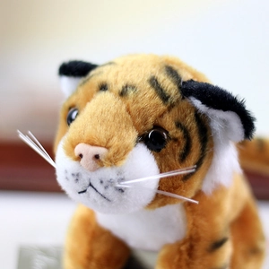 Close-up of lifelike tiger plush toy face with detailed whiskers and soft fur textures
