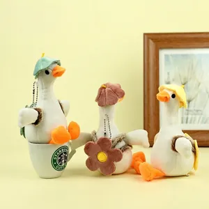Three 18cm cute plush duck keychain pendants with colorful hats on a yellow background