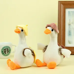 Detailed view of plush white duck dolls with sun hats and turtle shell backpacks