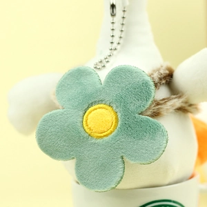 Detailed macro view of a plush flower keychain with green petals and silver bead chain
