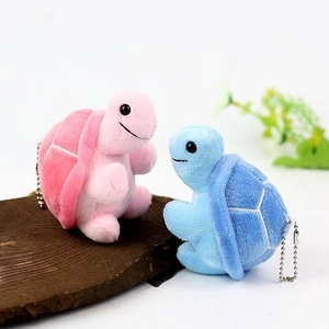 Pair of plush turtle keychains in pink and blue with soft fabric and metal chains