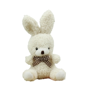 Cute sitting cream plush rabbit with curly fleece texture and brown checkered bowtie