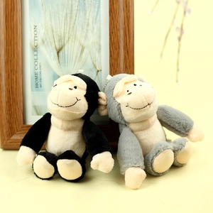 Gros plan de porte-clés peluche singe gris et noir avec texture douce et broderie