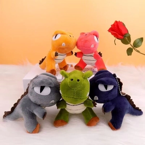 Plush dinosaur keychains in five colors on a soft white background for bags