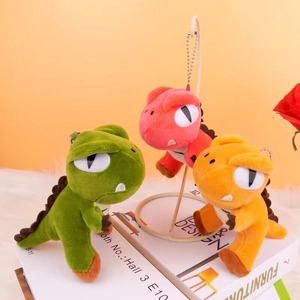 Cute plush dinosaur keychains in green orange and pink with soft velvet texture