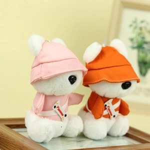 Detail of two white plush puppies wearing colorful sun hats and Freedom branded shirts