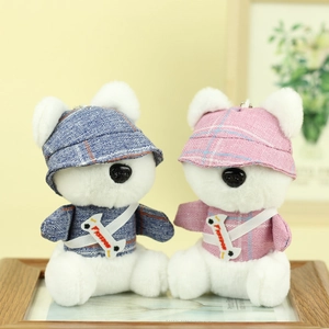 Detail of cute plush bear keychains wearing plaid shirts and freedom bone charms