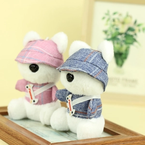 Close-up of cute plush bear charms in blue and pink plaid outfits with crossbody straps