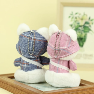 Detail view of pink and blue checkered plush bear keychains with metal chains