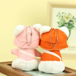 Rear view of pink and orange plush bears wearing sun hats with metal ball chains
