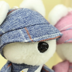 Macro detail of the plush puppy toy showing soft fur texture and denim beret hat