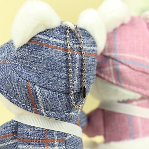 Detail of plush keychain showing plaid hat texture and silver metal bead chain