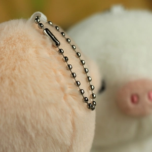 Close-up of pink plush pig pendant with durable dark grey metal bead chain link
