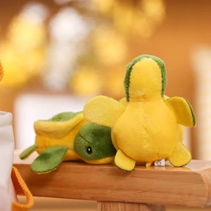 Detail of plush turtle keychains featuring soft yellow and green fabric textures