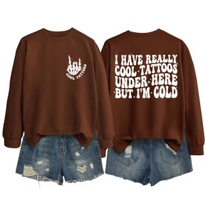 Brown crewneck sweatshirt with 'COOL TATTOOS' bone hand print and slogan on back detail
