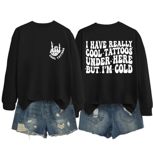 Detail of black crewneck sweatshirt with humorous white text print and rock hand gesture