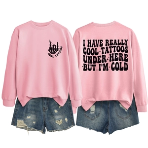Pink sweatshirt detail showing cool tattoos back print and distressed denim shorts