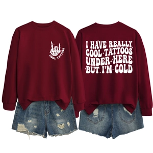 Detail of burgundy crewneck sweatshirt with white skeleton hand and slogan printing