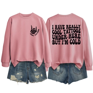 Pink oversized sweatshirt showing front and back print details with denim shorts