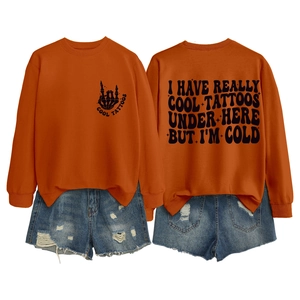 Close-up of orange sweatshirt with Cool Tattoos print on front and back designs