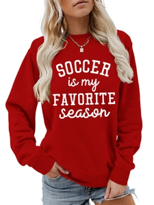 Detail eines roten Oversize-Sweatshirts mit dem Aufdruck SOCCER IS MY FAVORITE season