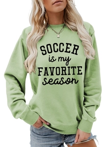 Detail eines salbeigrünen Oversize-Sweatshirts mit Soccer is my Favorite Season-Print