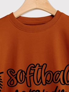 Detail of terracotta sweatshirt with ribbed crew neck and black softball text print