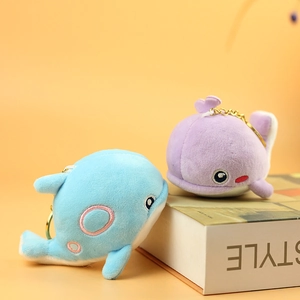 Cute plush whale keychains in light blue and purple with soft fabric and gold chains
