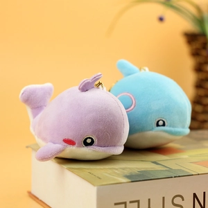 Detail of plush dolphin keychains in lavender and light blue with fine embroidery