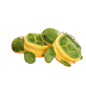Cute green turtle plush keychain with hexagonal shell patterns and metal ring attachment