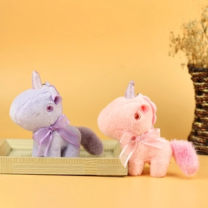 Cute purple and pink plush unicorn keychains with glittery horns and bow ties