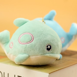 Close-up of mint and blue plush dolphin keychain with embroidery and gold metal ring