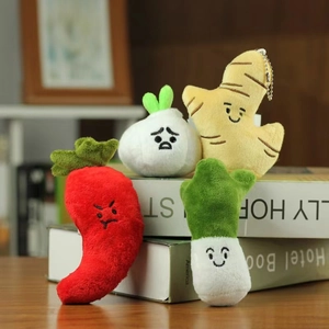 Detailed close-up of cartoon vegetable plush keychains including garlic and chili