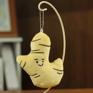 Close-up of cute plush ginger keychain with embroidered smile and metal chain