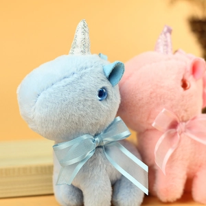Close-up of soft blue unicorn plush pendant with sparkling horn and silk bow detail