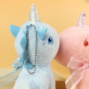 Detail of plush unicorn charms with sequin horns, satin bows and metal ball chains
