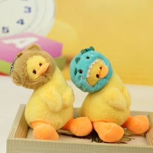 Cute yellow plush duck keychains with bear and dinosaur hats in a cozy display